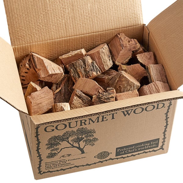 A cardboard box filled with Mesquite wood chunks.