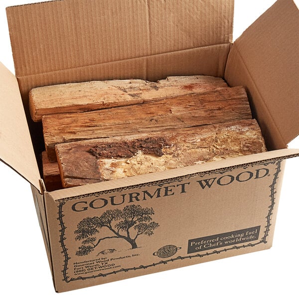 A cardboard box full of cherry wood logs.