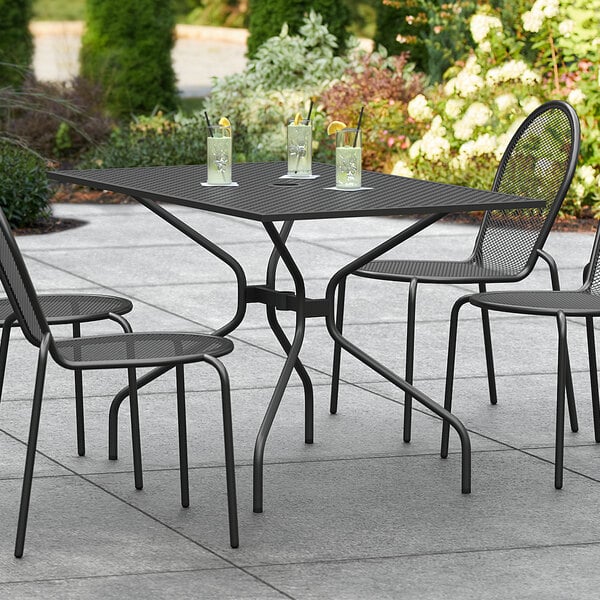 A Lancaster Table & Seating rectangular outdoor table with drinks on it.