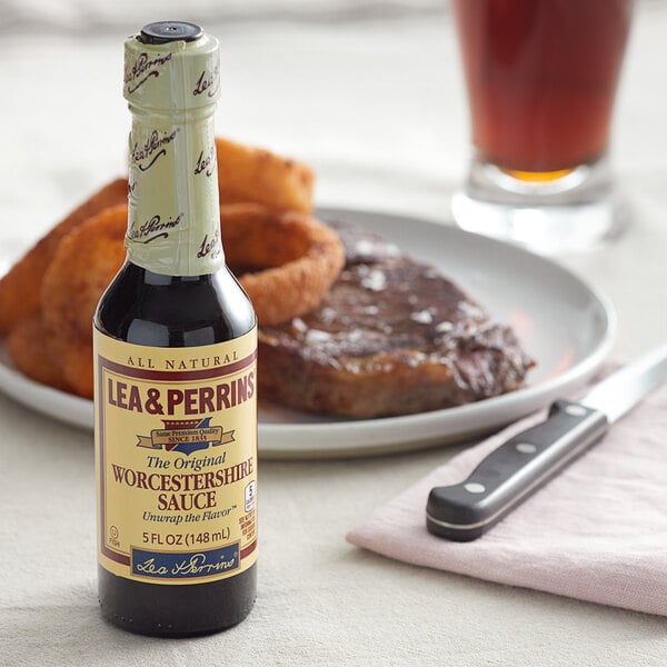 A Lea & Perrins Worcestershire sauce bottle next to a plate of food.