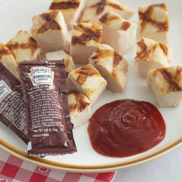 A plate of food with a Heinz BBQ sauce packet on it.