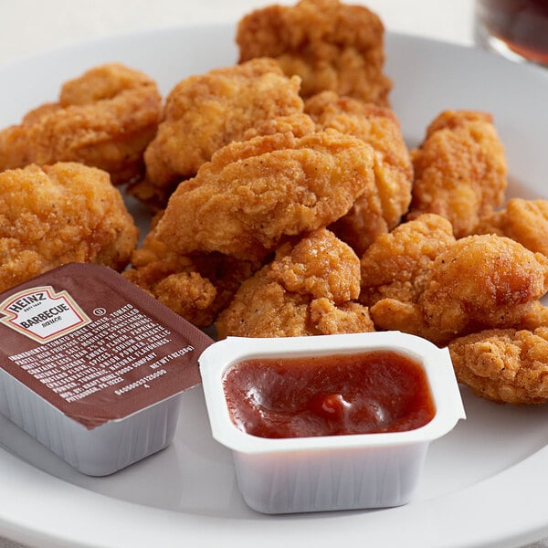 A plate of fried chicken with Heinz BBQ sauce.