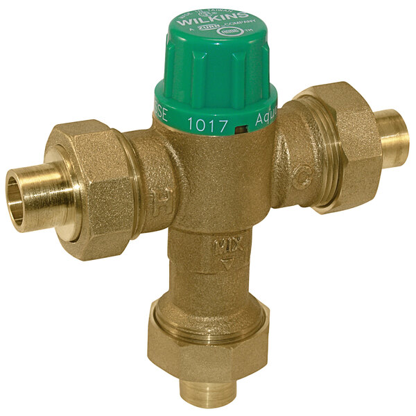 A close-up of a Zurn brass Aqua-Gard tempering mixing valve with green and yellow buttons.