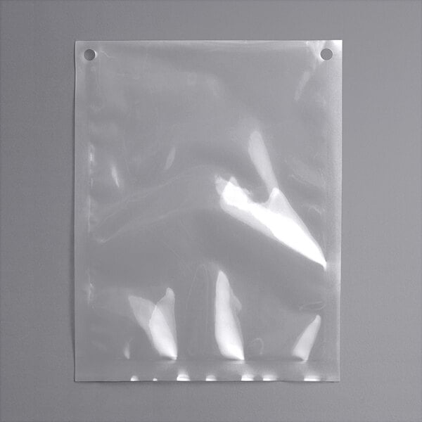 VacPak-It 7" x 9" chamber vacuum packaging pouch with holes on a grey surface.
