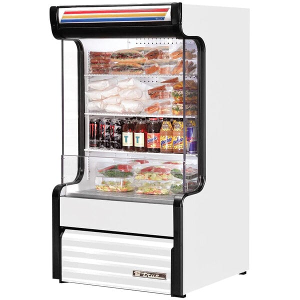 A white True refrigerated air curtain merchandiser with food inside.