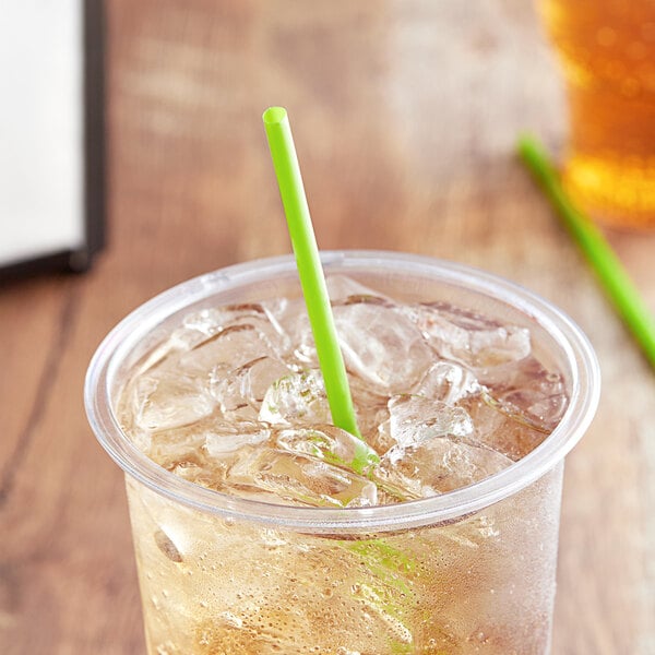 A clear cup of iced tea with a green EcoChoice compostable straw.