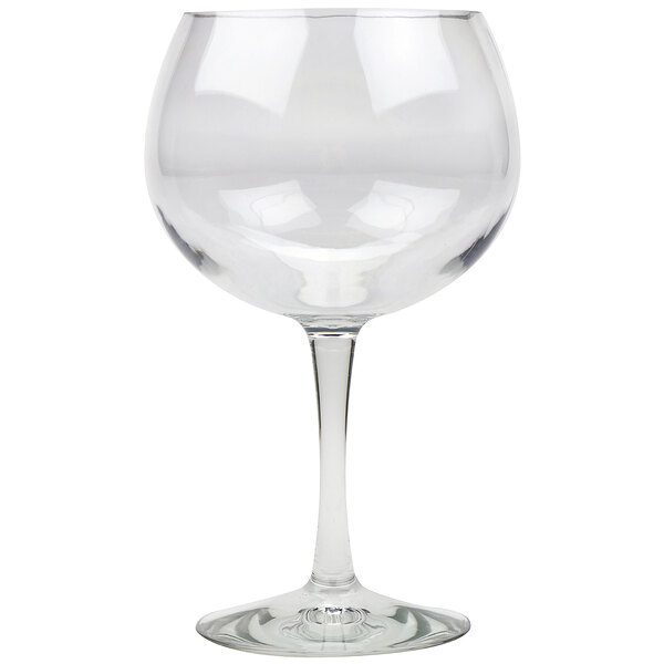A clear Tritan plastic gin and tonic glass with a stem.