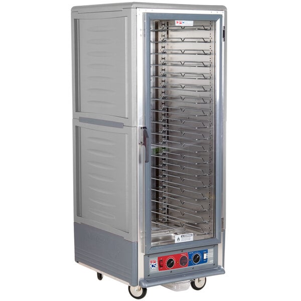 A gray Metro C5 heated holding and proofing cabinet with clear door and shelves on wheels.