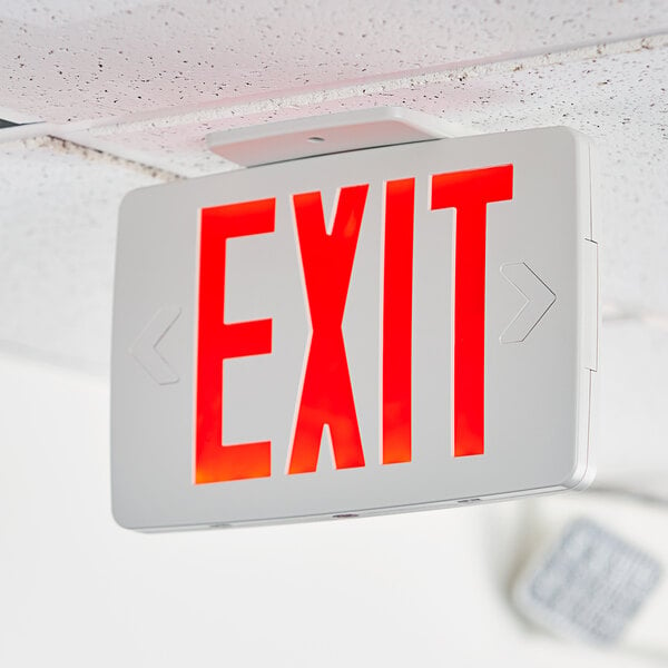 A white rectangular Lavex red LED exit sign hanging from a ceiling.