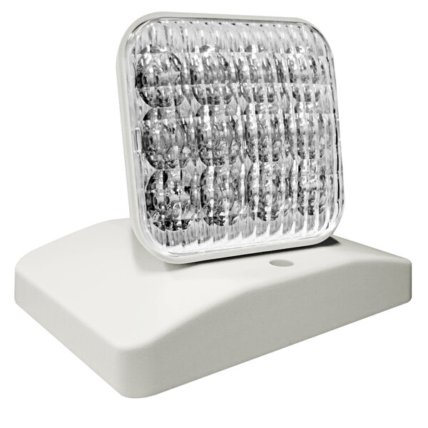 A white rectangular Lavex emergency light with a square object on top.