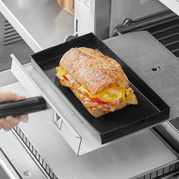 A sandwich being cooked in a Baker's Mark non-stick basket inside a rapid cook oven.