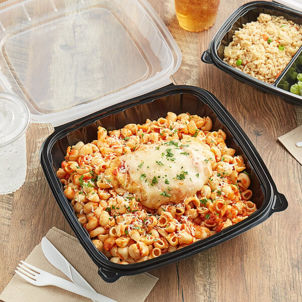 A black plastic Choice 1-compartment container with pasta and cheese on top.