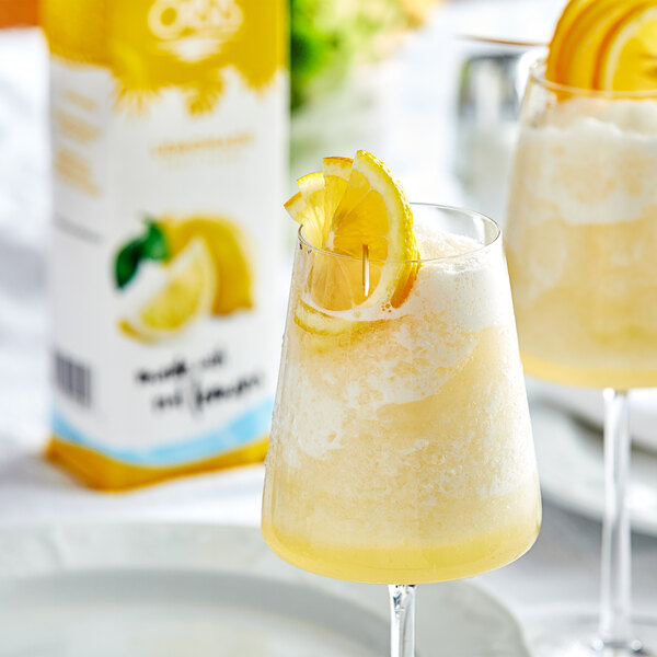 Two glasses of Island Oasis lemonade with lemon slices on top.