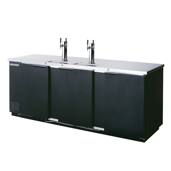 A black Beverage-Air kegerator with three taps on a counter.