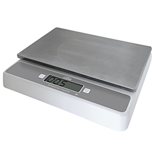 A CDN digital portion scale with a silver top and white base on a counter.