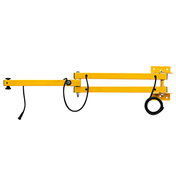 A yellow metal TPI Fostoria loading dock arm with black cords.