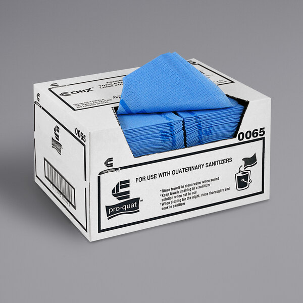 A case of blue Chicopee Chix foodservice towels on a counter.