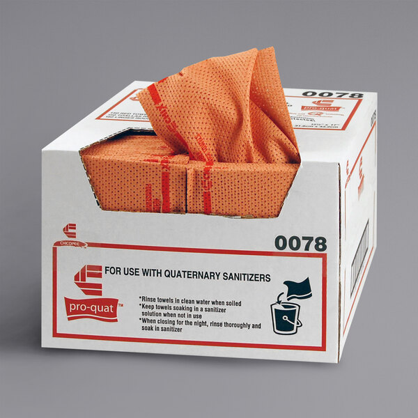 A case of red Chicopee foodservice towels with tissue paper in the box.