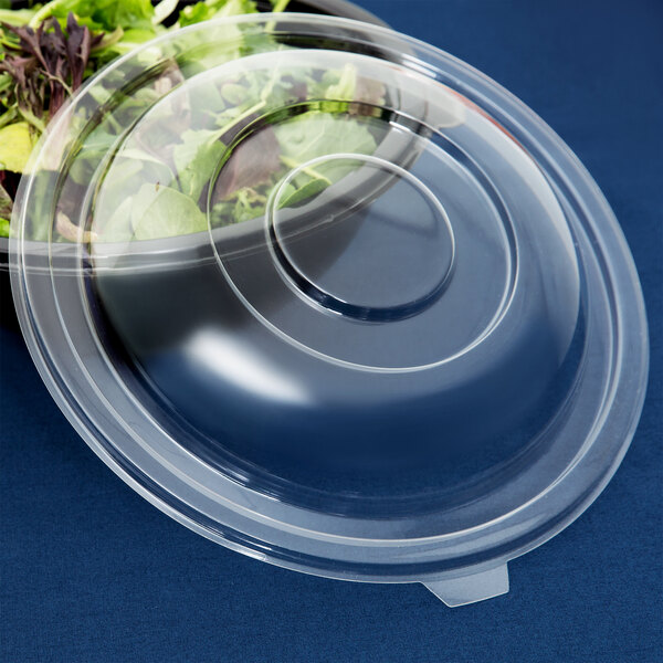 A clear plastic Fineline dome lid on a salad bowl.