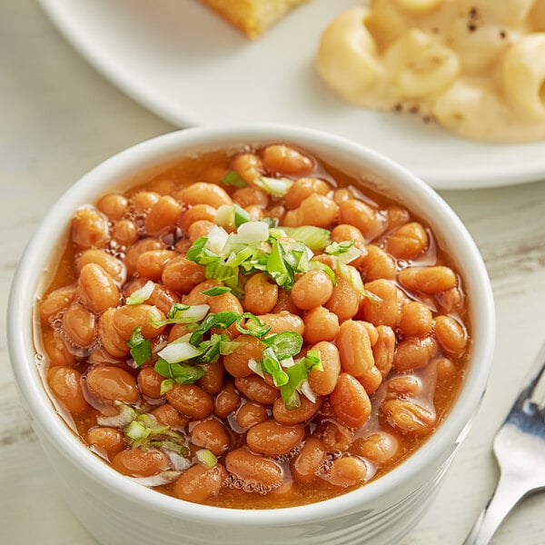 A bowl of Furmano's New England style vegetarian baked beans with green onions.