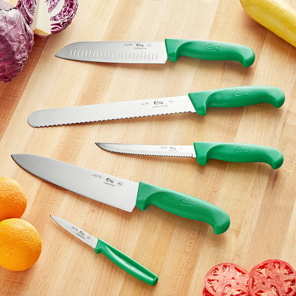 A Choice 5-piece knife set with green handles in a white box on a table.