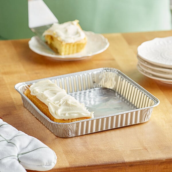 A frosted cake in a Choice square foil pan.