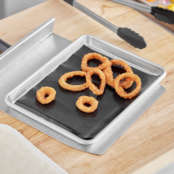 Baker's Mark non-stick release sheets with fried onion rings on a bun pan.