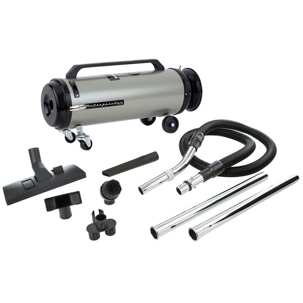 A MetroVac Professional Evolution canister vacuum with tube and hose accessories.