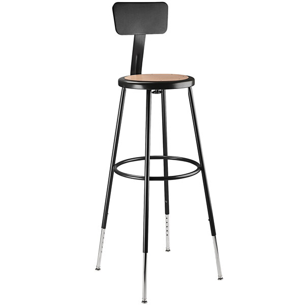 A black metal lab stool with a round hardboard seat.