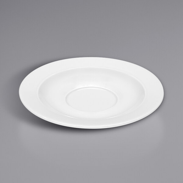 A Bauscher bright white round porcelain saucer on a gray surface.
