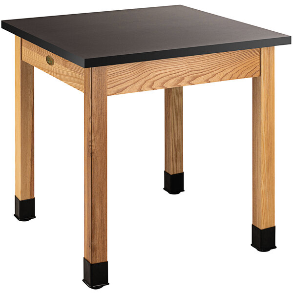 A black square National Public Seating science lab table with legs and a black phenolic top.