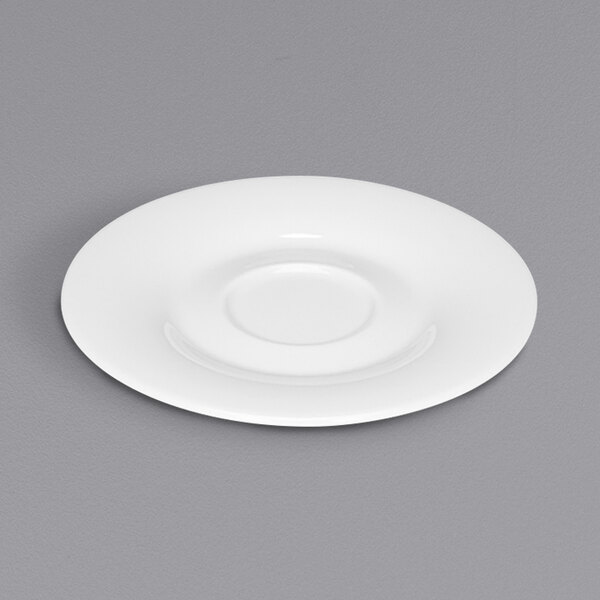 A Bauscher bright white round porcelain saucer on a white plate.