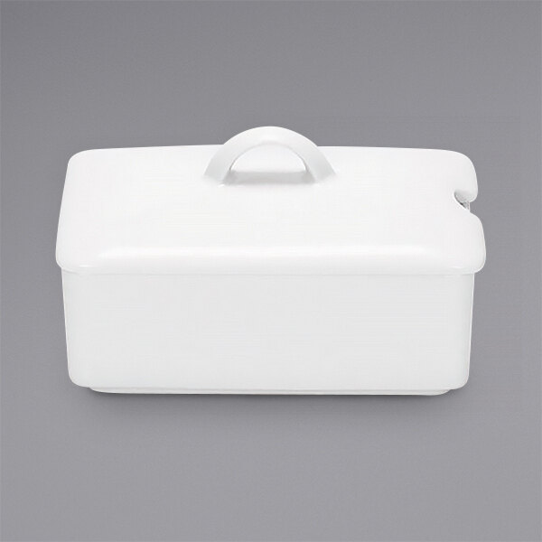 A white rectangular porcelain container with a white lid with a handle.