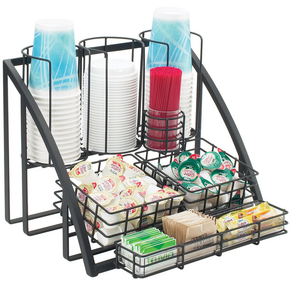 A black metal Cal-Mil condiment organizer with a variety of cups and condiments.
