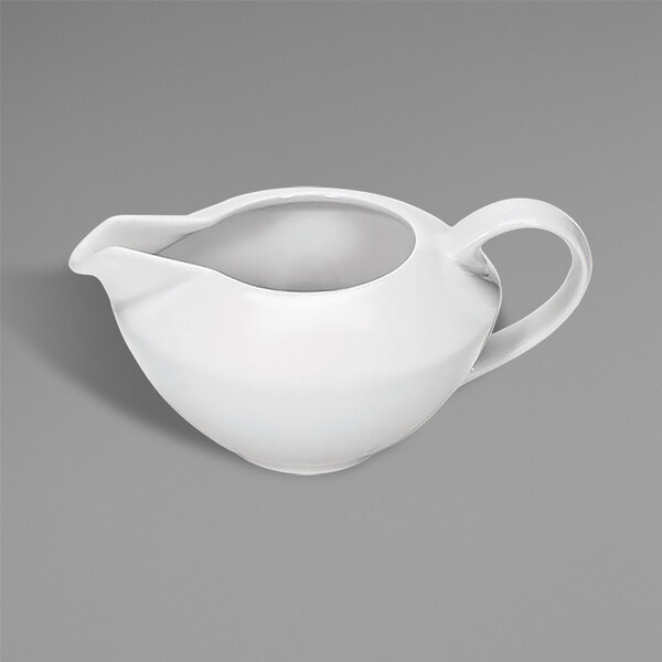 A white ceramic sauce pot with a handle.