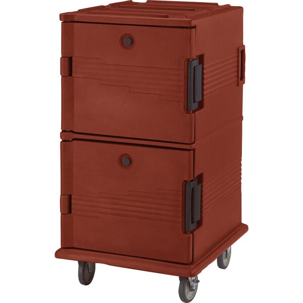 A Cambro brick red plastic Ultra Camcart for food pans on wheels.