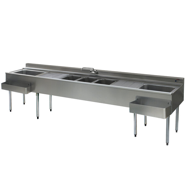 A stainless steel Eagle Group underbar sink with three sinks, two drainboards, one faucet, and two ice bins.