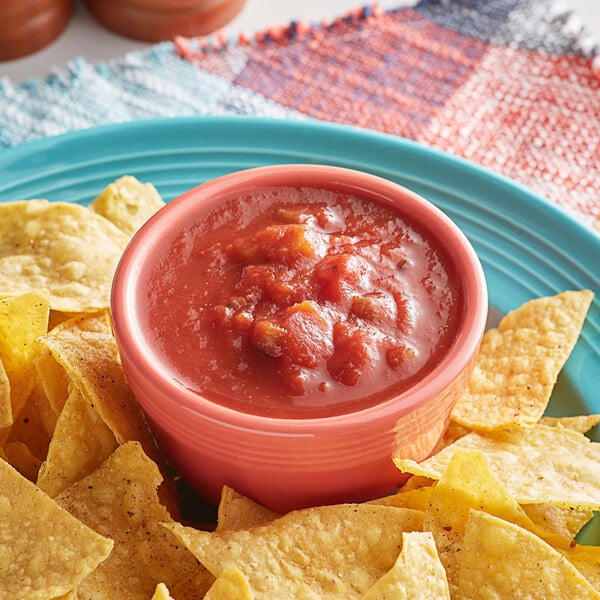 A bowl of Dei Fratelli medium salsa on a plate of tortilla chips.