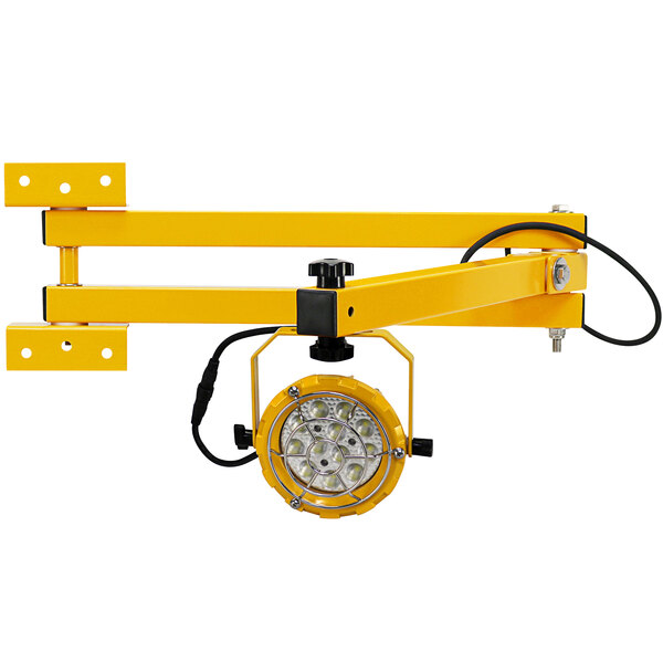 A yellow TPI Fostoria LED loading dock light with a round light.