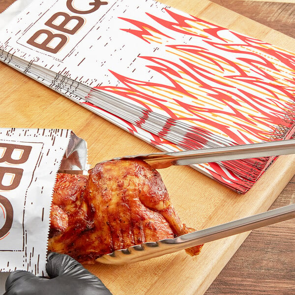 A person using a knife to cut up food on a table in a Choice insulated foil BBQ bag.