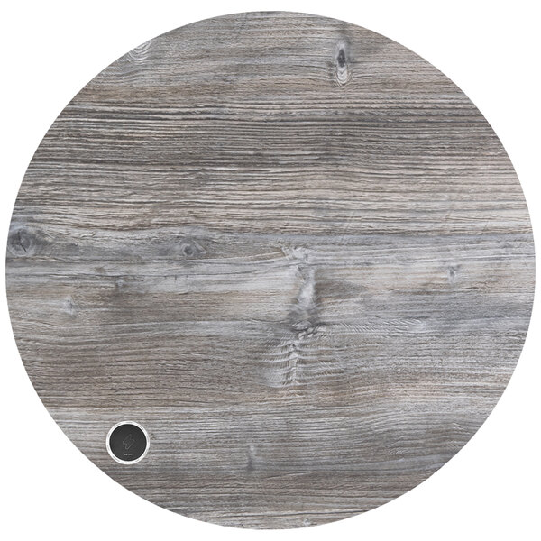A BFM Seating Midtown round wood table top with a black circle on it.