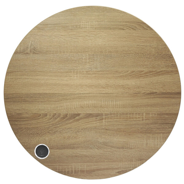 A BFM Seating round wood tabletop with a wireless charger in a circular wood surface with a small circle.