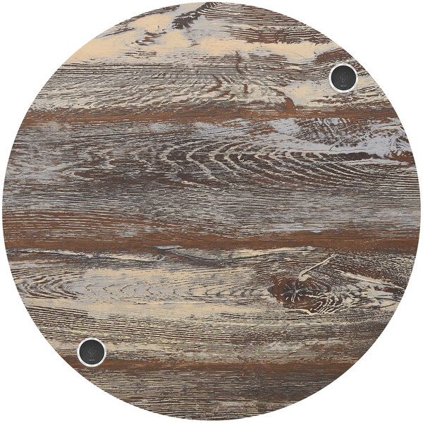 A BFM Seating Relic round wood table top with wireless charger holes.