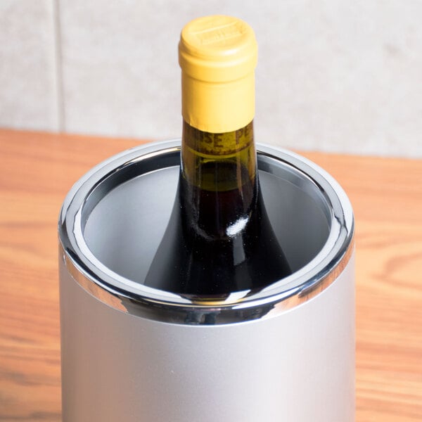An American Metalcraft silver acrylic wine cooler holding a bottle of wine.
