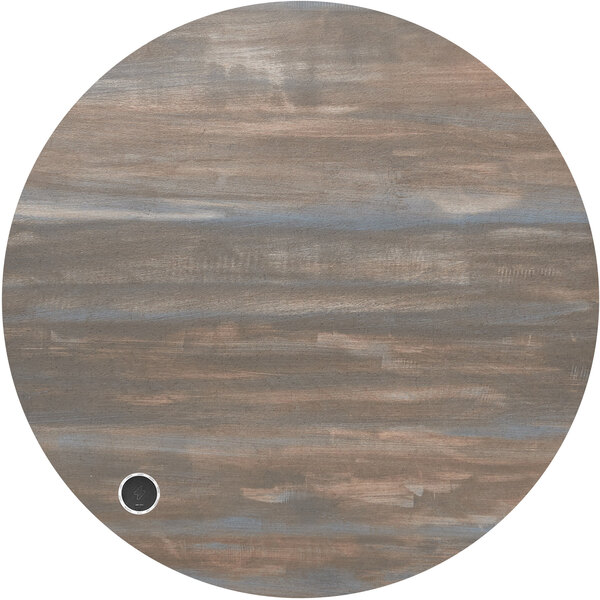 A BFM Seating round chestnut melamine table top with a black circle and a wireless charger.
