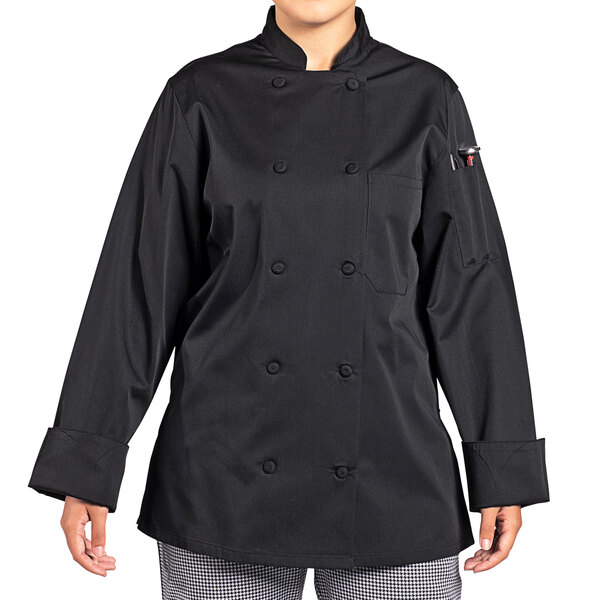 A woman wearing a black Uncommon Chef long sleeve chef coat with a mesh back.