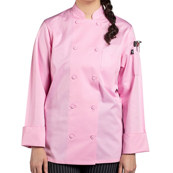 A woman wearing a pink Uncommon Chef long sleeve chef coat with a mesh back.