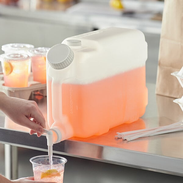A woman pouring an orange and white drink into a Choice plastic beverage container.