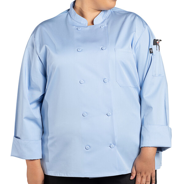 A woman wearing a Uncommon Chef sky blue long sleeve chef coat.