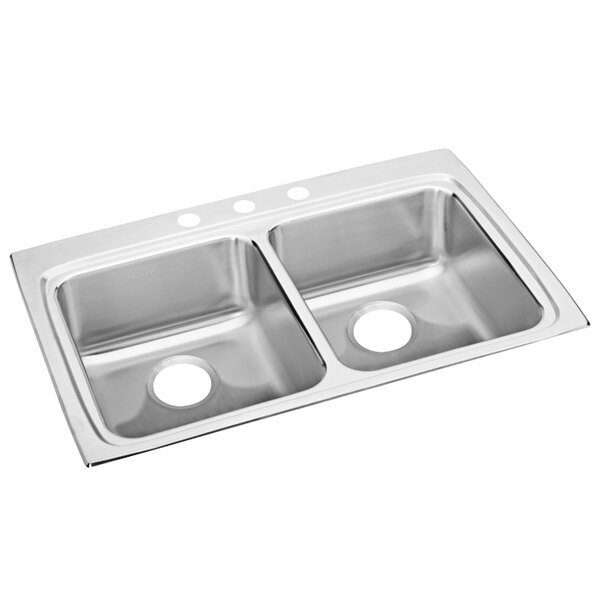 A stainless steel Elkay double bowl drop-in sink with three faucet holes on a counter.
